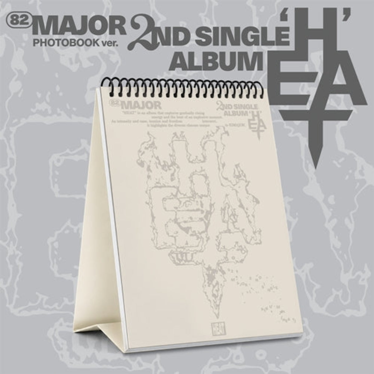 A freestanding spiral-bound photobook album from the band Major, shown open against a gray patterned background with large text reading '82 MAJOR PHOTOBOOK ver. 2nd Single Album'.